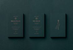 three green books with gold lettering on the front and back covers, against a dark green background