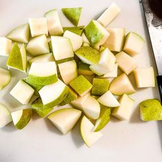 chopped up green and white apples on a cutting board