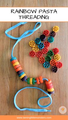 the rainbow pasta threading necklace is made with colorful beads and plastic tubes, on a wooden surface