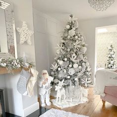 a white christmas tree in the corner of a room