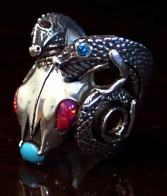 "Original \"art-you-wear\" by Reyes Alfonso Ulibarri.  Handcrafted of sterling silver, (shown also in 14k yellow gold), set with natural blue turquoise, lab-created opals and natural blue topaz, red sapphire, and/or natural gold-vein turquoise.  Sterling silver options begin at $590.00  14k Yellow gold options begin at $4,990.00  Please contact us for exact pricing and custom options.  Completion time is 3-4 weeks from the time order is placed. All of our made-to-order pieces have a wide variety Twin Dragons, Ram Skull, Red Sapphire, Special Ring, Natural Gold, Mens Ring, Men's Ring, Gold Set, Turquoise Sterling Silver