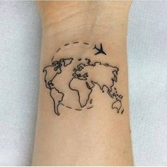 a small wrist tattoo with a world map and birds flying around the world on it