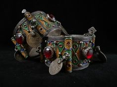 A high graded silver set of old Berber hinged enameled bracelets of Tiznit, Morocco, 1950s. I bought them in 2006 in Tiznit. Overall in good condition. The bracelets have each 4 red glass cabochons and 4 old French coins (50 centimes).On both bracelets there are engravings, see picture 3 Total weight is 225,6 grams ( 113,1 + 112,5). The width of a bracelets is 3.6 cm The inner Ø IS 5.8 CM Antique Enamel Bracelet Collectible, Traditional Enamel Jewelry Collectible, Vintage Festival Bracelet Jewelry, Vintage Festival Jewelry Bracelet, Antique Enamel Bracelets For Gifts, Antique Enamel Bracelets As Gift, Vintage Inlay Bracelet Jewelry, Vintage Jewelry Bracelet With Inlay, Vintage Inlay Jewelry Bracelet