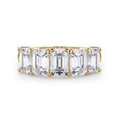 an emerald - cut diamond ring with three baguets on the sides and four diamonds in