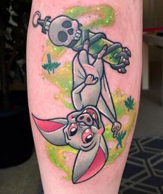 a cartoon tattoo on the leg of a person with a skull and crossbones