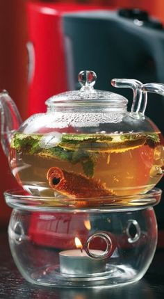 a glass tea pot filled with green tea