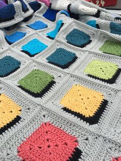 a crocheted blanket with squares on it