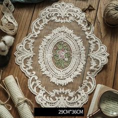 a table topped with lots of different types of yarn and crafting supplies on top of a wooden floor