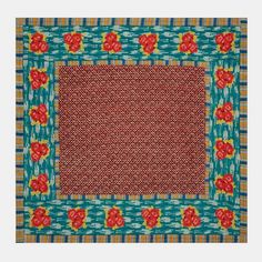 a red and blue square rug with flowers on the border, in front of a white background