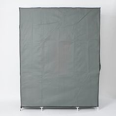 the back side of a large gray sheet on a white background with two legs in front of it