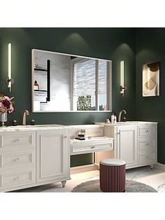 a bathroom with green walls and white vanity, large mirror over the double sink area