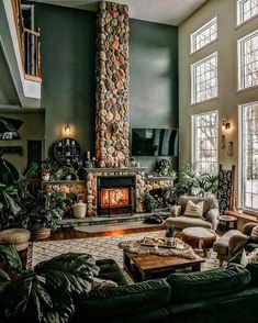 a living room filled with furniture and a fire place in the middle of two windows