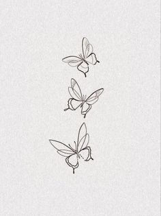 three butterflies flying in the air on a white paper background with black ink and pen