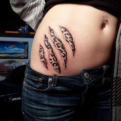 a woman's stomach with an animal print tattoo on her lower back and side