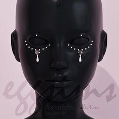 a black mannequin head with white pearls on it's face and nose