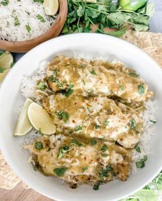 a white bowl filled with rice covered in sauce and garnished with cilantro