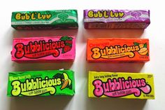 four bars of bubblelicious are lined up on a white surface, each with different flavors