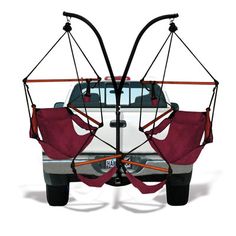 two hammock chairs attached to the back of a white truck with black straps