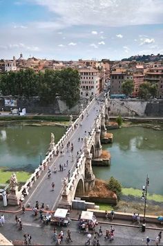 people are riding bikes on a bridge over a river