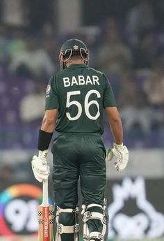 a man standing on top of a field holding a bat