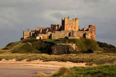 an old castle sitting on top of a hill