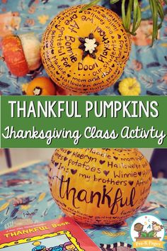 two pumpkins with writing on them sitting on a table next to an open book