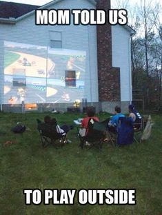 some people are sitting in lawn chairs watching a movie on the big screen with words mom told us to play outside