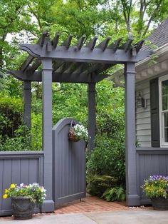 an image of a small garden with flowers on the fence and in front of it