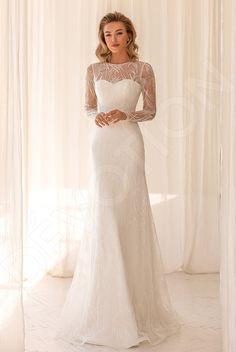 a woman in a white wedding dress posing for the camera with her hands on her hips