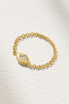 a gold chain bracelet with a single diamond on it's end and a tiny leaf charm