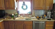 a kitchen with wooden cabinets and a silver dishwasher