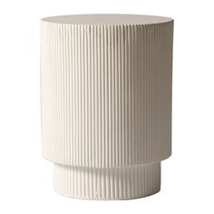 a white vase sitting on top of a table