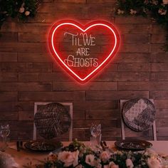 there is a neon sign that says, i love are ghost's on the wall