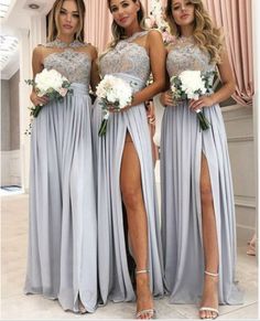 three bridesmaids in grey dresses posing for the camera with their legs split open