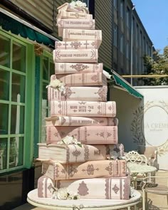 a tall stack of books sitting on top of a table next to a green door