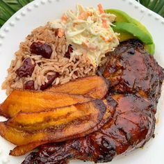 a white plate topped with meat and rice