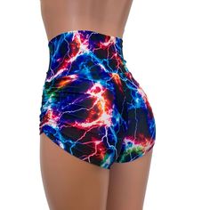 High-waisted booty shorts made in sparkle cosmic thunder UV Glow print stretchy performance spandex with ruching on the sides and lace-up detail in front. Made to flatter your figure and move with you. These booty shorts shine in different colors in the light - for a true holographic effect. The standard inseam is 2.5" - but can be customized. Stretch Rave Shorts, Multicolor Stretch Rave Shorts, Fitted Rave Bottoms With Built-in Shorts, Fitted Rave Shorts, Trendy Fitted High Waist Athletic Shorts, Stretch Rave Shorts For Summer, Blue Stretch Rave Bottoms, Summer Rave Stretch Shorts, Trendy Fitted Shorts For Swimming