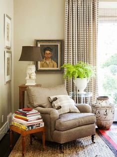 a living room filled with furniture and a painting on the wall next to a window