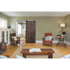 a living room filled with furniture and a sliding door in the middle of the room