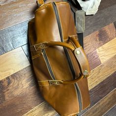 Pure Leather Duffle Bag. Never Used It, Plastic Still Wrapped Around The Bottom Pegs. Brown Leather Shoulder Duffle Bag, Leather Carry On Bag, Leather Duffle Bag, Leather Duffle, Duffel Bags, Carry On Bag, Duffel Bag, Carry On, Duffle Bag