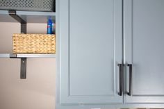 a basket is hanging on the cabinet doors