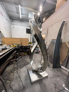 a large metal sculpture sitting on top of a table in a room filled with construction materials