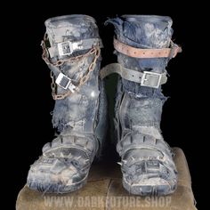 an old pair of boots that have been worn and chained to the ground with chains on them