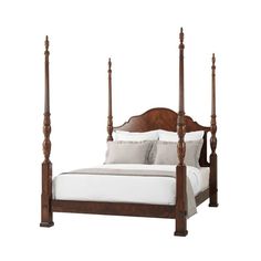 a bed with four posts and white sheets