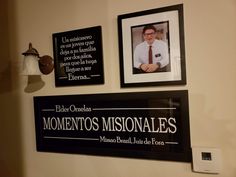 two framed pictures hang on the wall above a sign that reads, momentos misionales