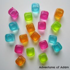 there are many different colored ice cubes on the table with words adventures of adam