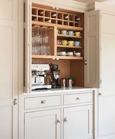 an open cabinet with wine glasses on it