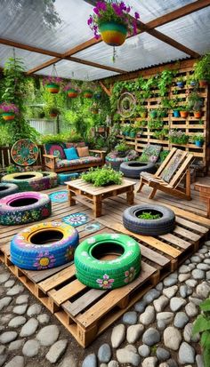 an outdoor area with wooden pallets and colorful tires on the ground, surrounded by plants