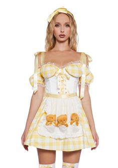 a woman wearing a yellow and white dress with teddy bears on it