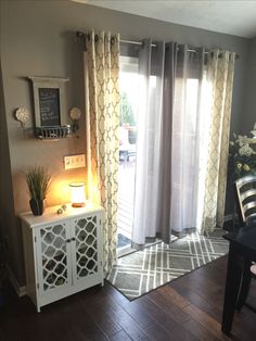 a dining room with a table and chairs next to a sliding glass door that opens onto a patio